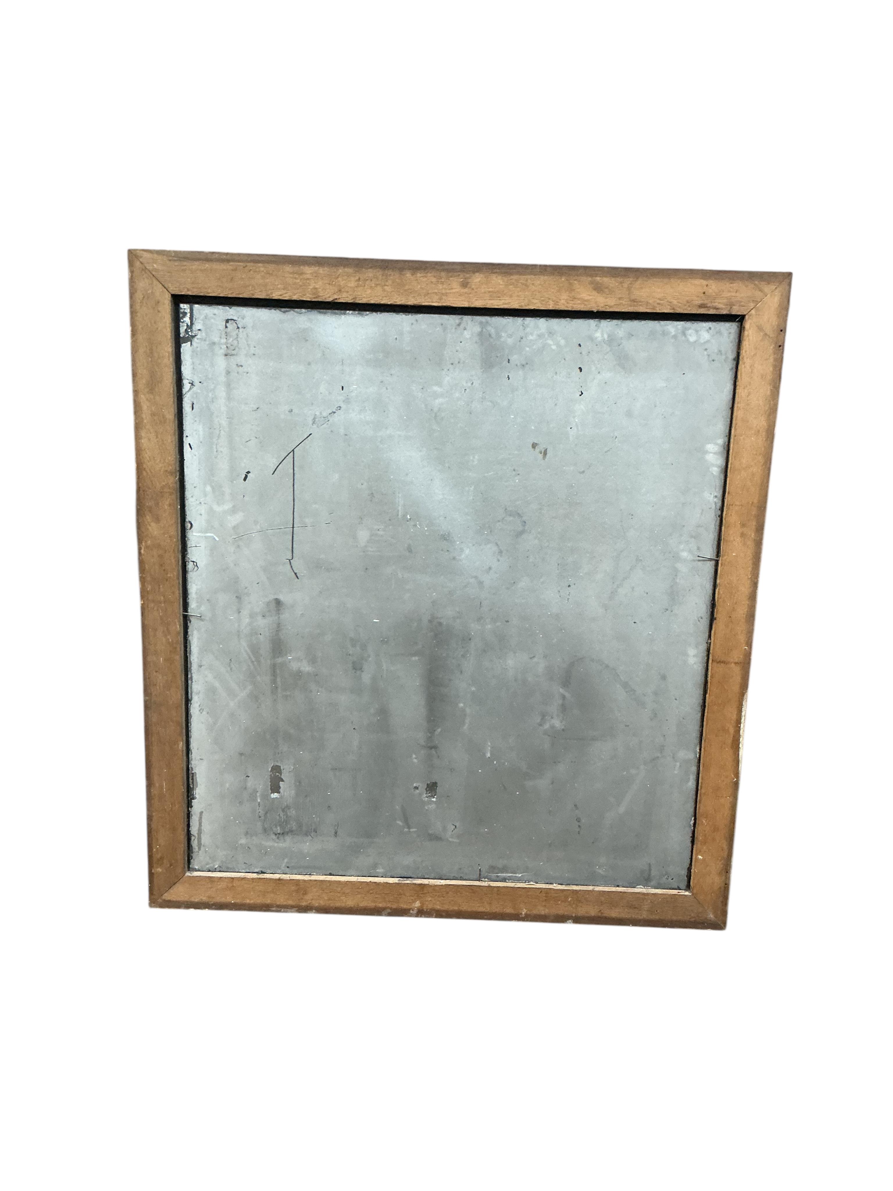 An Edwardian rectangular oak framed wall mirror with foxed plate, width 115cm, height 125cm